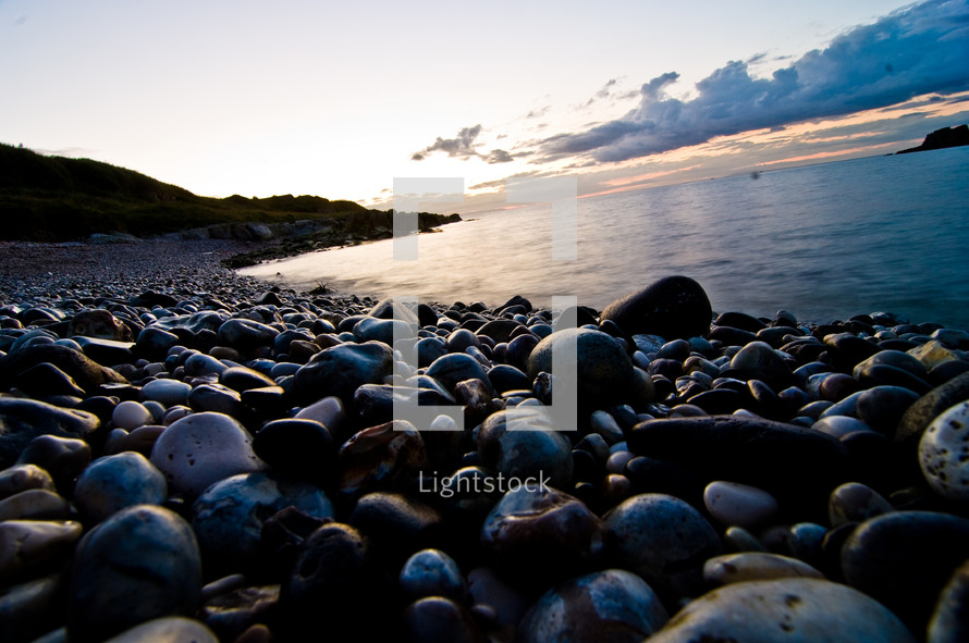 stones along a shore at dusk
