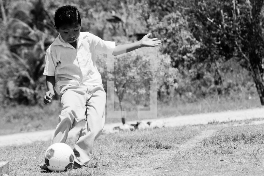 a boy child with a soccer ball 