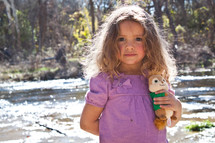 girl child holding onto a stuffed animal 
