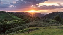 Colorful sunrise morning over beautiful green nature in New Zealand countryside landscape
