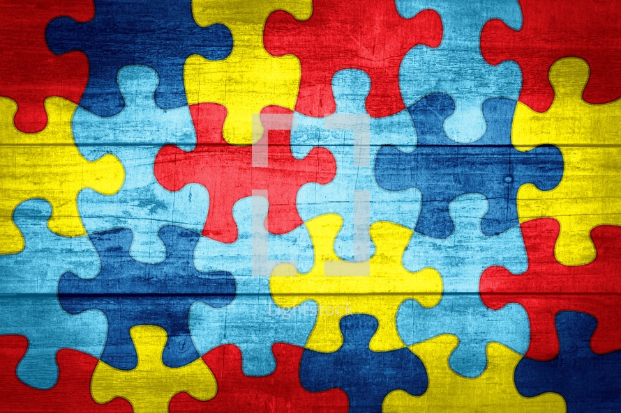 autism puzzle piece background on wood 