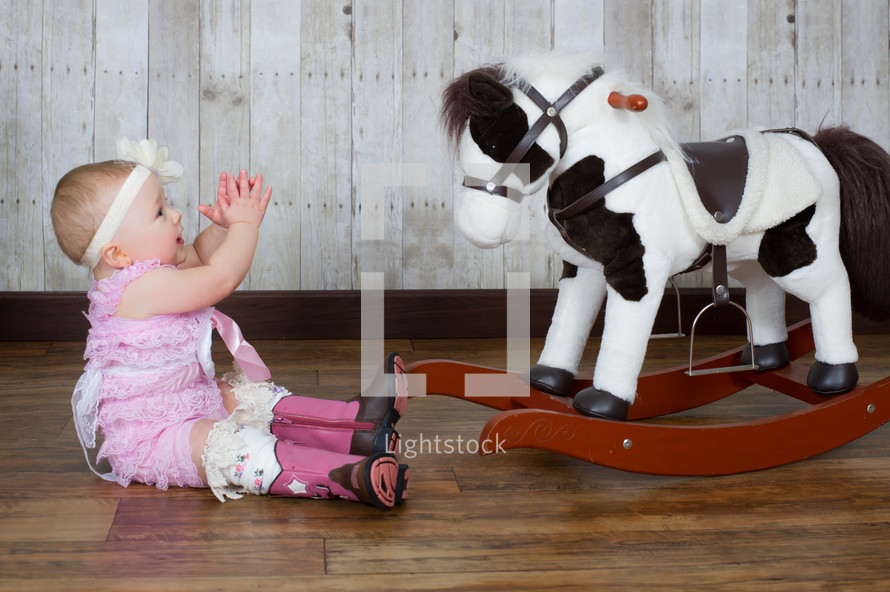 infant and rocking horse 