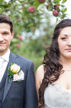 bride and groom in an apple orchard 