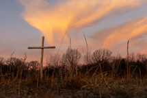 A wooden cross at sunrise.