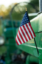 American flag on the side of a green tractor 
