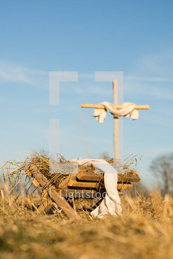 a cross and manger in the field