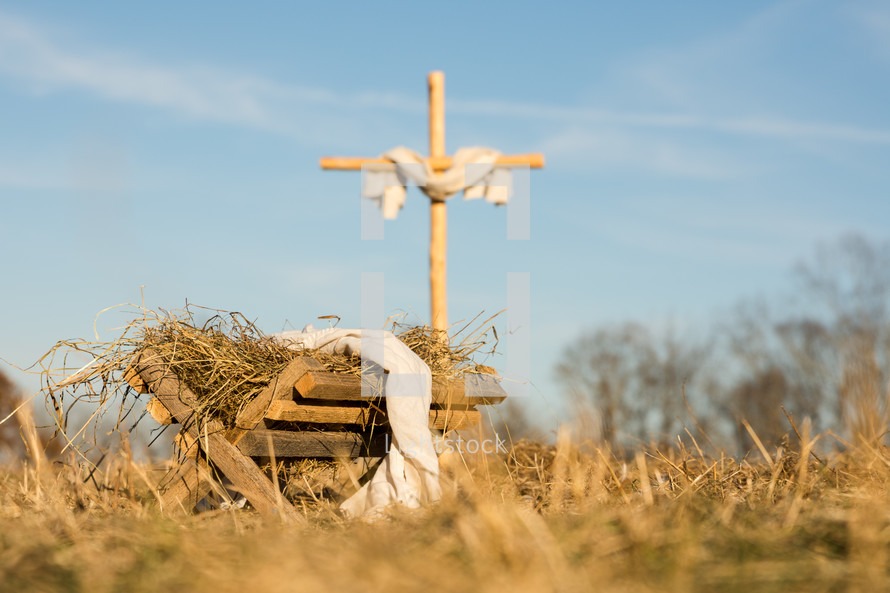 a cross and manger in the field