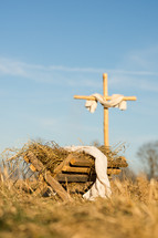 a cross and manger in the field