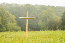 a wooden cross in a field