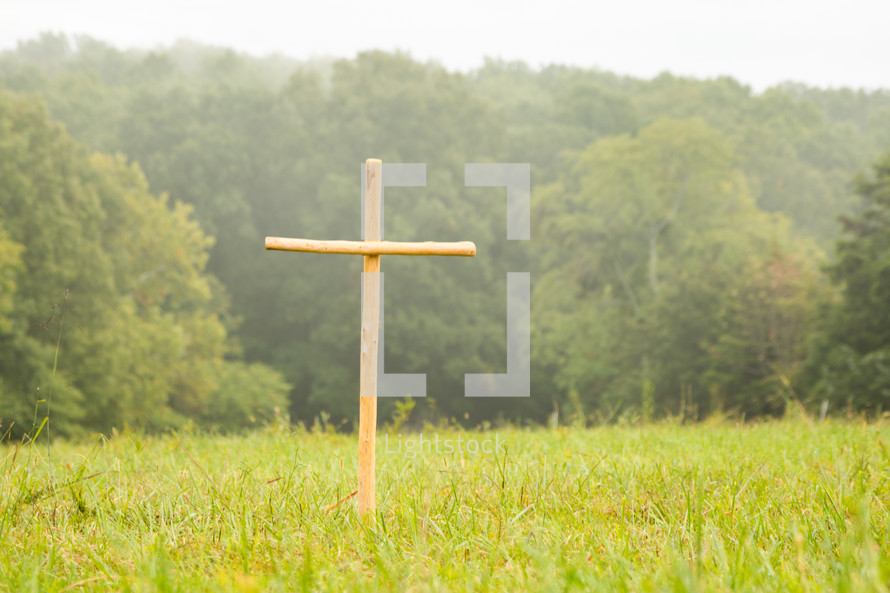 a wooden cross in a field