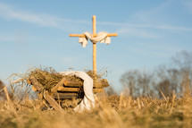 a cross and manger in the field