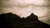 Clouds behind rock formations.