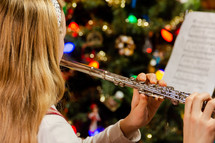 A girl playing the flute at Christmas time