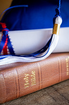 blue graduation cap and Bible 