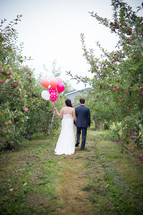 bride and groom in an apple orchard