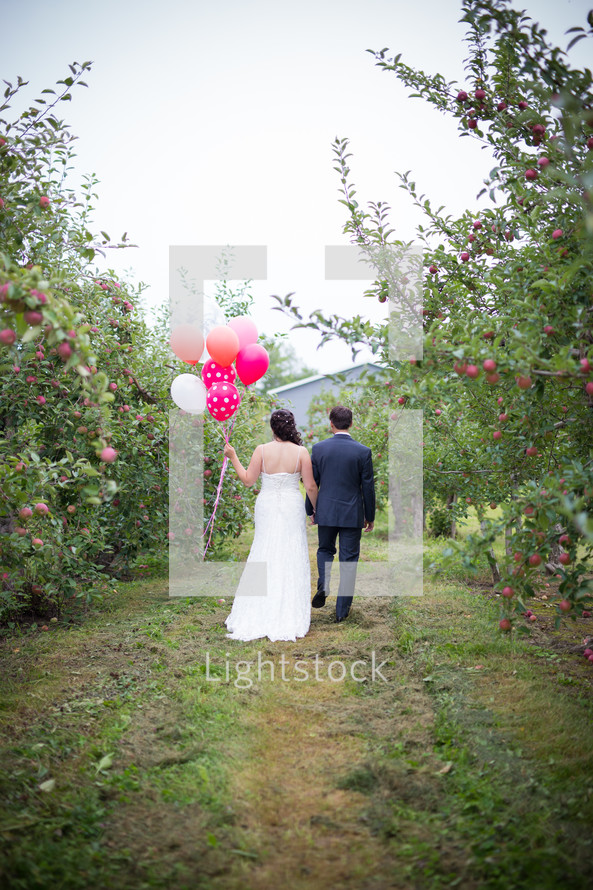 bride and groom in an apple orchard