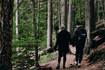 couple walking on a forest path 