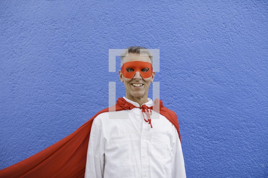 a father in a superhero cape 