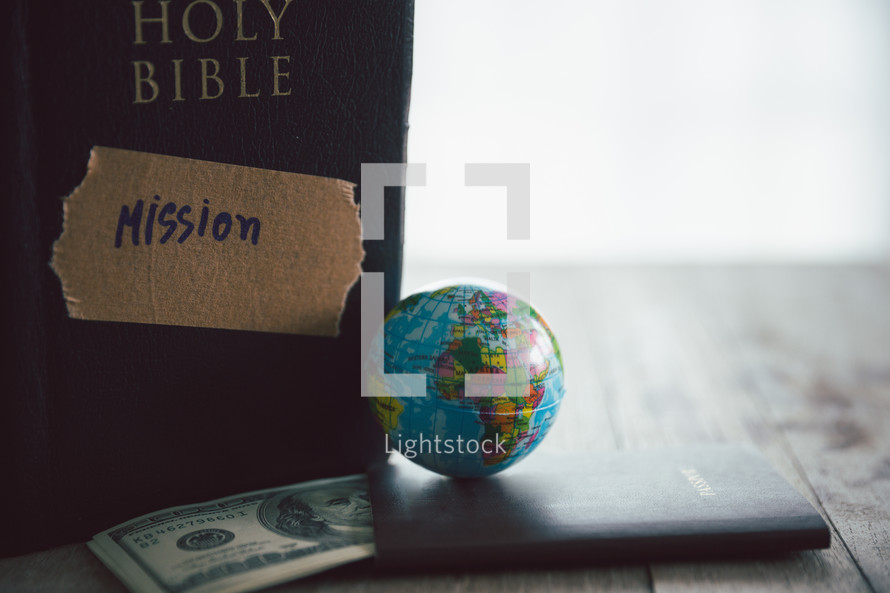 Globe and money with a Bible