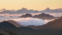 Colors of sunset evening with clouds in misty mountains nature in New Zealand wilderness Time lapse
