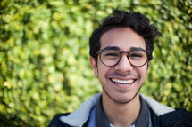 face of a smiling man in glasses 