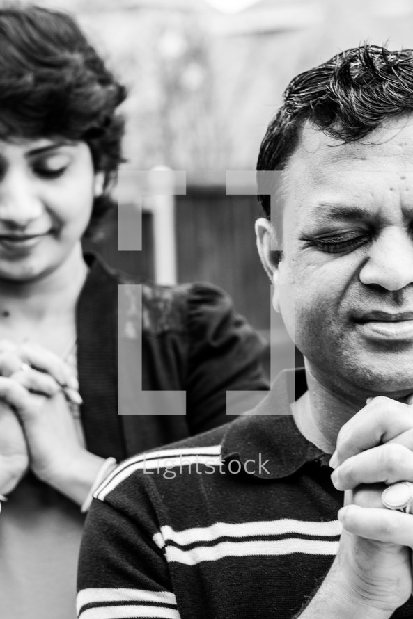 faces of an Indian couple in prayer 