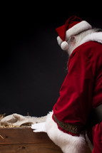Santa visiting baby Jesus in the manger 