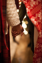 people holding hands in prayer at a Christmas party 