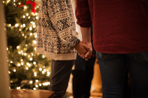holding hands in prayer at a Christmas party 