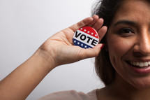 young woman with vote button 