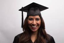 smiling graduate in cap and gown 