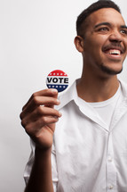 young man wearing a vote button 