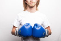 a man in blue boxing gloves 