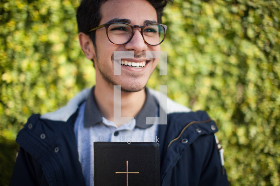 smiling man holding a Bible 