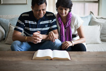 an Indian couple reading a Bible 
