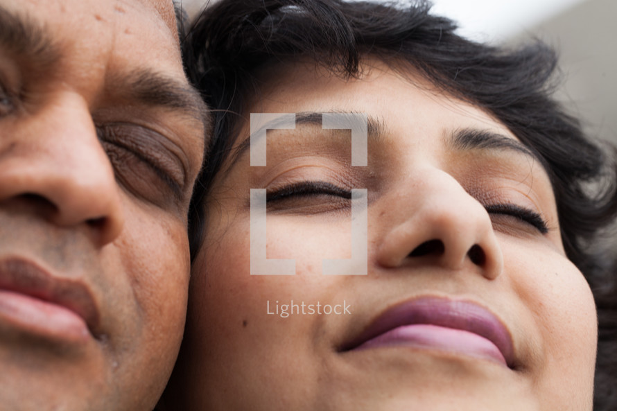 faces of an Indian couple in prayer 