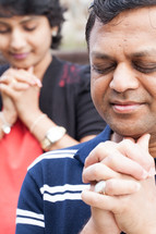 An Indian couple in prayer together 