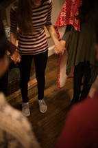 teens holding hands in prayer at a Christmas party 