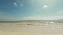 Beautiful beach timelapse video with blue skies, clouds, ocean waves, and sand in Cancun, Mexico.
