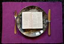 bible opened up at Matthew 4:4  on a plate, 