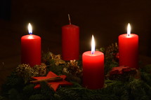Three candles are burning at the Advent wreath for the third advent. 