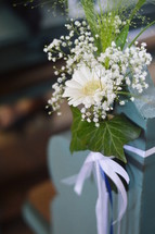 wedding flowers on a pew 