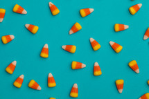 scattered candy corn on a blue background 