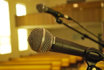 microphone and rows of church pews 