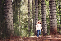 a child exploring a forest 