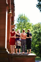 women standing together in front of a church 