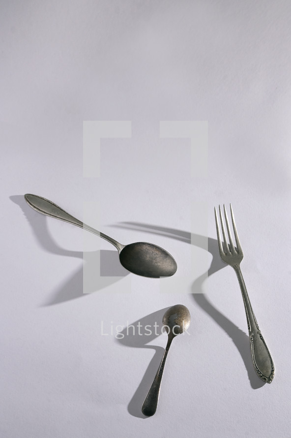 Abstract Silver Spoon and Fork Cutlery and shadows