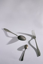 Abstract Silver Spoon and Fork Cutlery and shadows