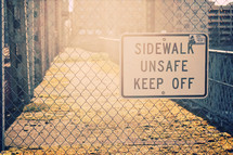 sidewalk unsafe keep off sign 