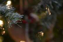 bell ornament on a Christmas tree and lights 